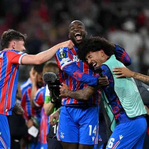 Crystal Palace's Jean-Philippe Mateta celebrates with teammates after winning the UEFA Conference League.