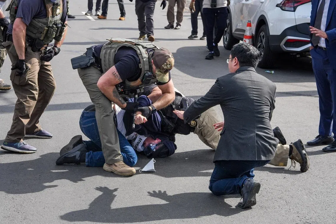 Democratic U.S. Senator Andy Kim gesturing as law enforcement officers detain a demonstrator outside Delaney Hall in Newark, New Jersey, U.S., on May 25, 2026. 
