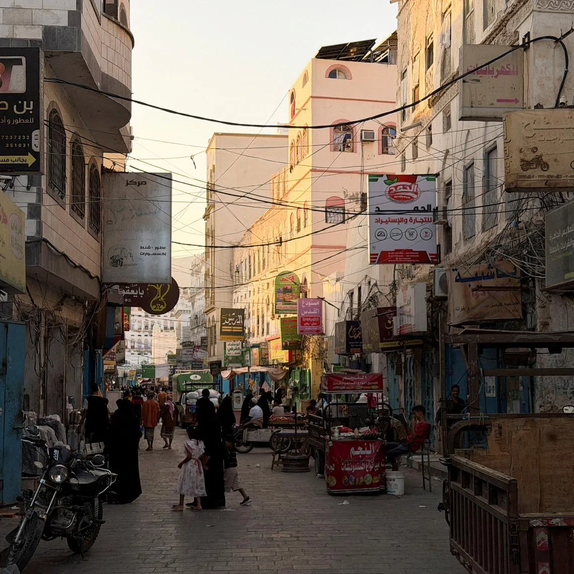 FILE PHOTO: People walk through a traditional market in the port city of Mukalla, Hadramout, Yemen, January 20, 2026. Picture taken with a mobile phone. REUTERS/Hamad I Mohammed/File Photo