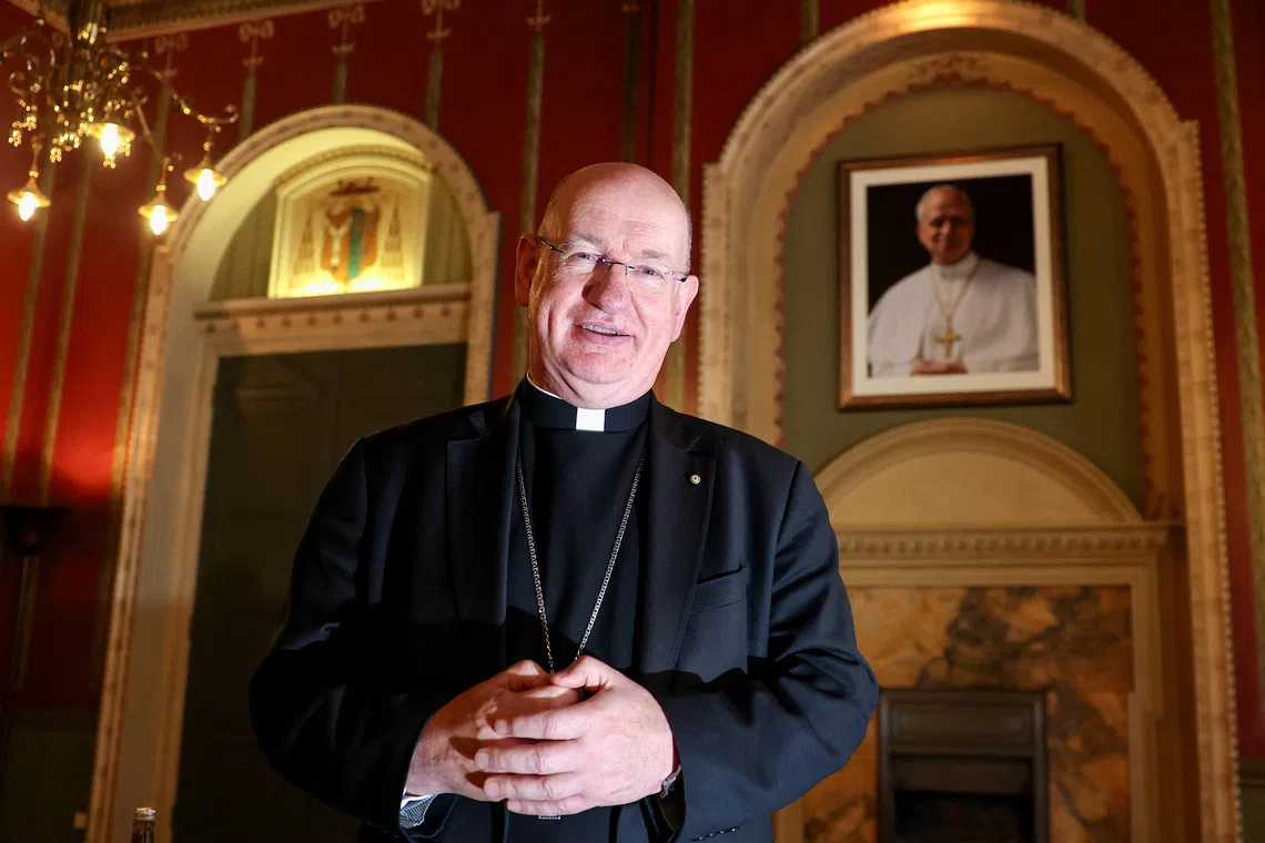 Richard Moth, newly appointed as Archbishop of Westminster, poses for a photograph in front of a portrait of Pope Leo XIV at the Archbishop's House, in London, Britain, December 19, 2025. REUTERS/Toby Melville