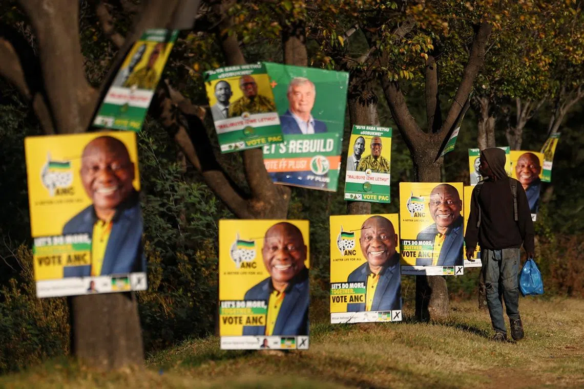 A man walks past election posters of the ruling African National Congress (ANC), as South Africa prepares for the May 29 general elections, in Soweto, South Africa, May 24, 2024. REUTERS/Siphiwe Sibeko