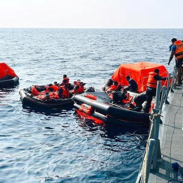 Sri Lanka Navy personnel assist Iranian sailors during a rescue operation after responding to a distress call from their vessel, the IRIS Dena.