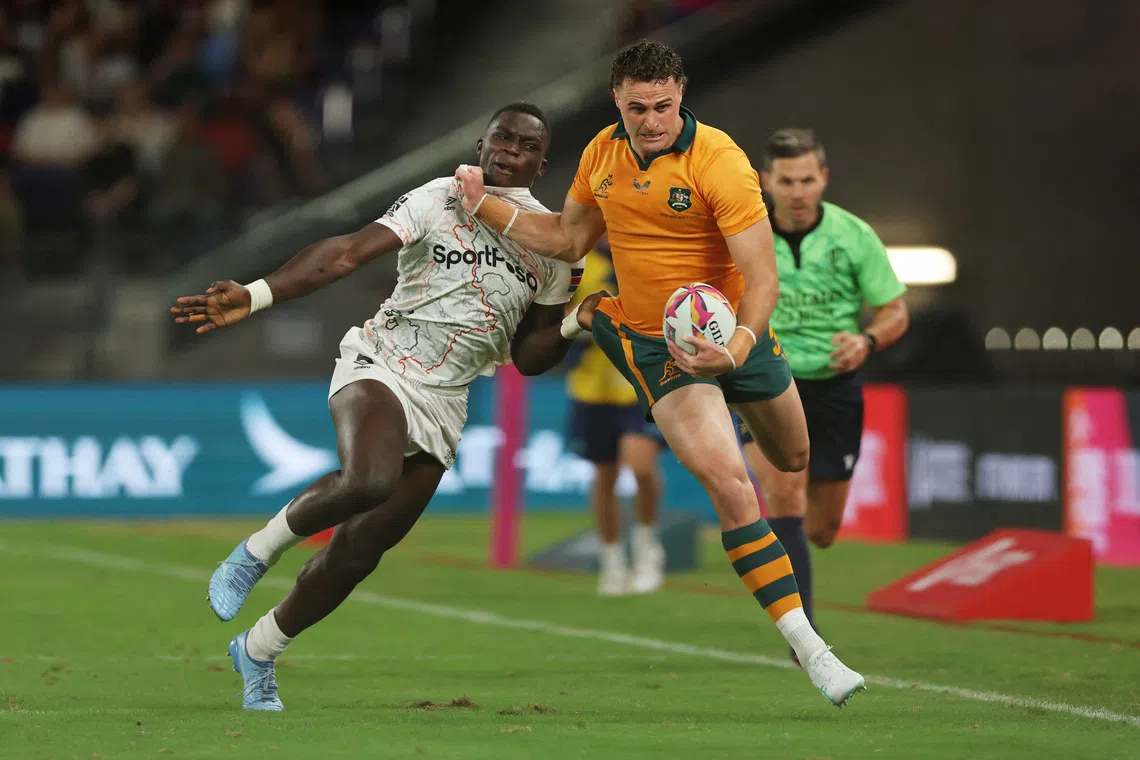 Rugby Union - HSBC Sevens World Championships - Hong Kong - Australia v Kenya - Kai Tak Sports Park, Hong Kong, China - April 17, 2026 Australia's Harry Wilson in action with Kenya's Kevin Wekesa Nyongesa REUTERS/Tyrone Siu