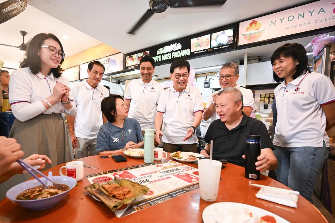 Potential PAP candidates Hazlina Abdul Halim (left) and Dinesh Vasu Dash (third from left) joining East Coast GRC incumbents (from left) Tan Kiat How, Heng Swee Keat, Edwin Tong and Jessica Tan on a walkabout on April 5.