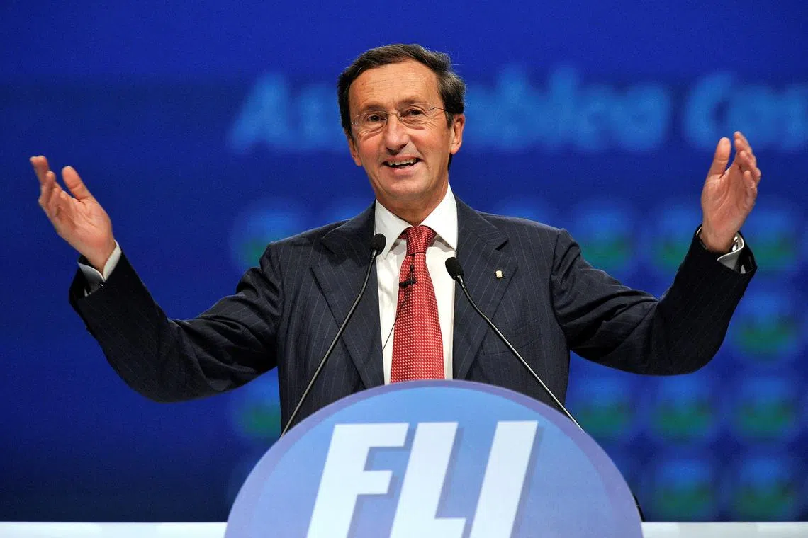 FILE PHOTO: Gianfranco Fini gestures as he delivers his speech at the first meeting of his new political party 'Futuro e Liberta' (Future and Freedom) in Milan, February 13, 2011.    REUTERS/Paolo Bona (ITALY - Tags: POLITICS)/File Photo