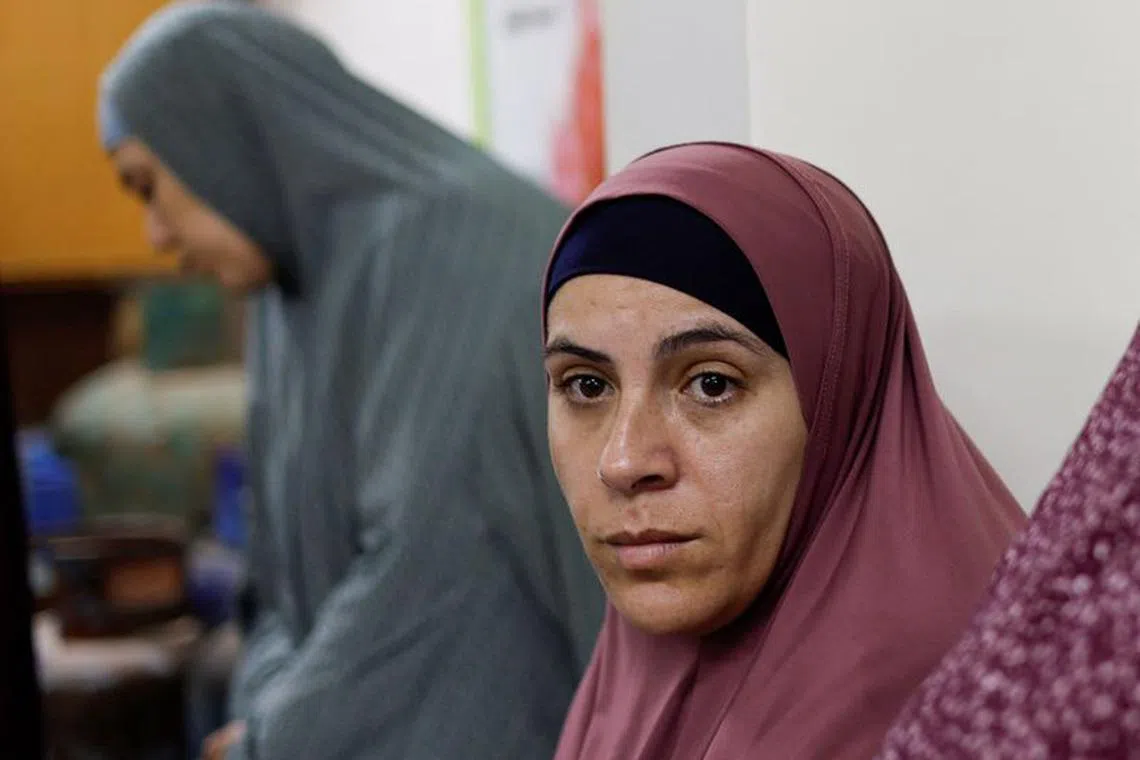 Palestinian woman Tamam al-Aswad who was imprisoned for weeks by Israel, looks on after her release as she takes refuge at a school in Rafah in the southern Gaza Strip, February 8, 2024. REUTERS/Mohammed Salem