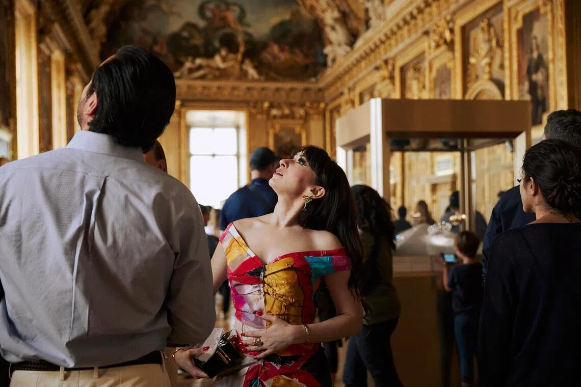 Ms Anya Firestone leads a tour through the Apollo Gallery at the Louvre Museum in Paris on June 22, 2023. 