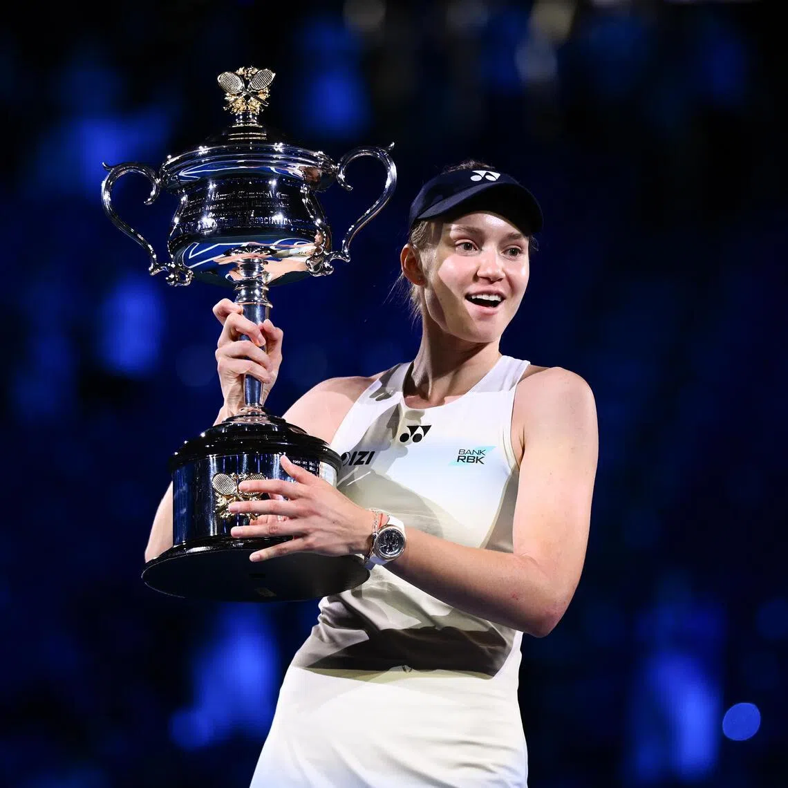 Elena Rybakina poses for photographs with the Daphne Akhurst Memorial Cup after winning the Australian Open final against Aryna Sabalenka.