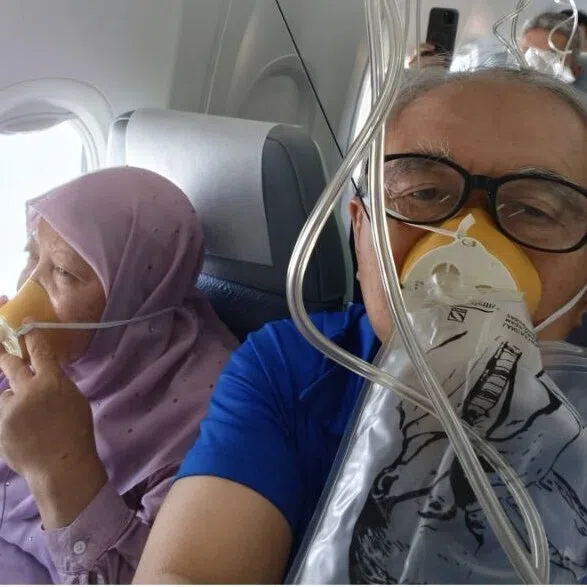 A passenger aboard flight MH2742 using the oxygen masks that were deployed.