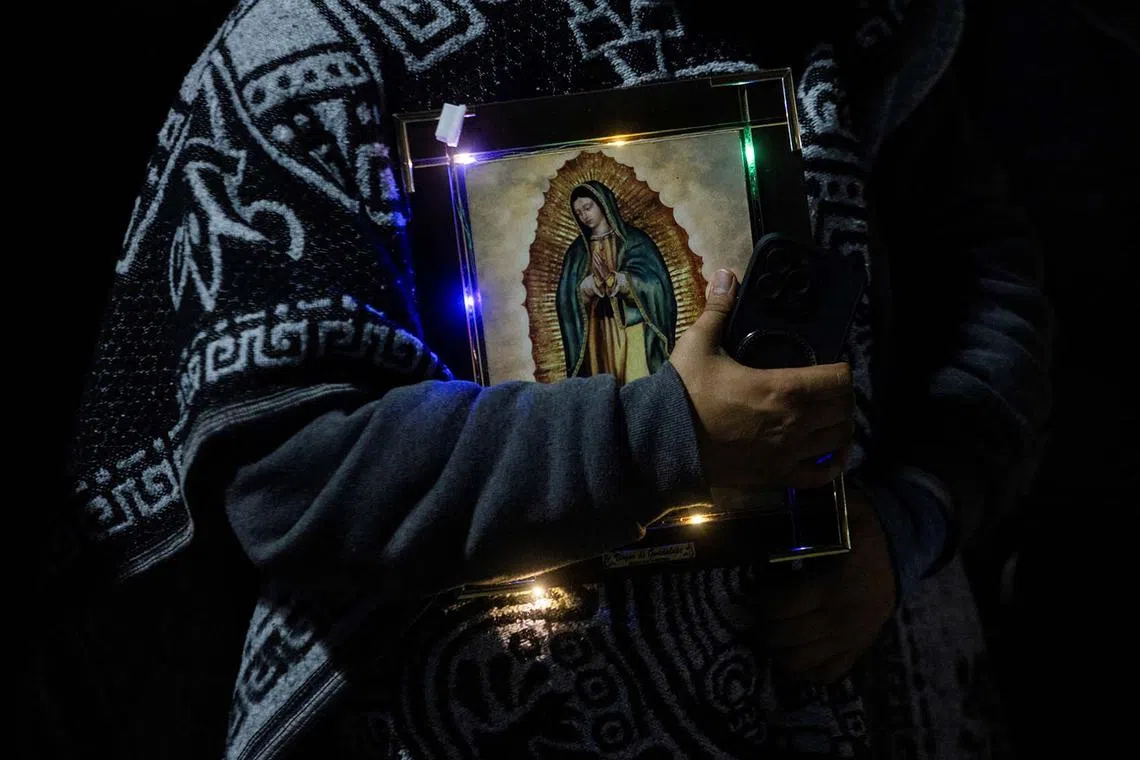 A Pilgrim holds an image of the Virgin of Guadalupe in the square of the Basilica of Our Lady of Guadalupe during the annual Virgin of Guadalupe feast day, in Mexico City, Mexico, December 12, 2023.REUTERS/Quetzalli Nicte-Ha TPX IMAGES OF THE DAY