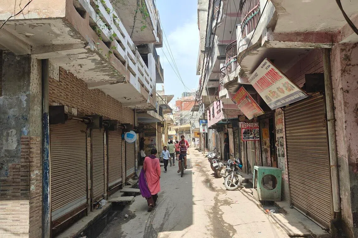 ddworkers - Many of the workers live in underdeveloped neighbourhoods where rents are low such as the one pictured here in Noida.

ST PHOTO: DEBARSHI DASGUPTA