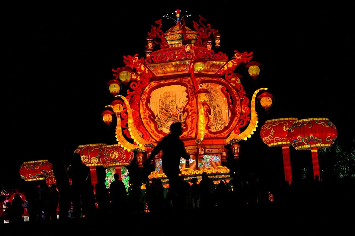 Local residents are seen in front of a light installation during the Chinese Lanterns Festival in Santiago, Chile December 22, 2022. 