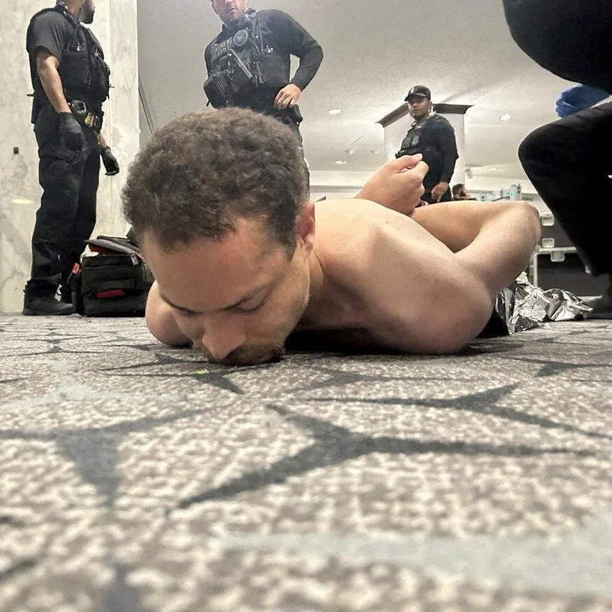 Law enforcement personnel detaining suspect Cole Allen at the White House Correspondents' Association dinner in April 2026.