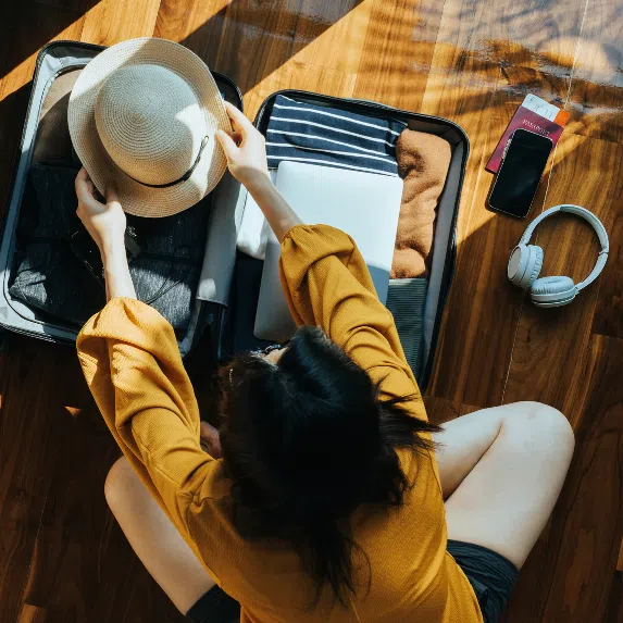 Woman packing luggage for holiday
