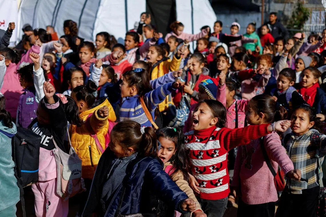 Displaced Palestinian students gather outside a tent near the Israeli-designated "yellow line" in Beit Lahiya, northern Gaza Strip, on Jan 6, 2026. 
