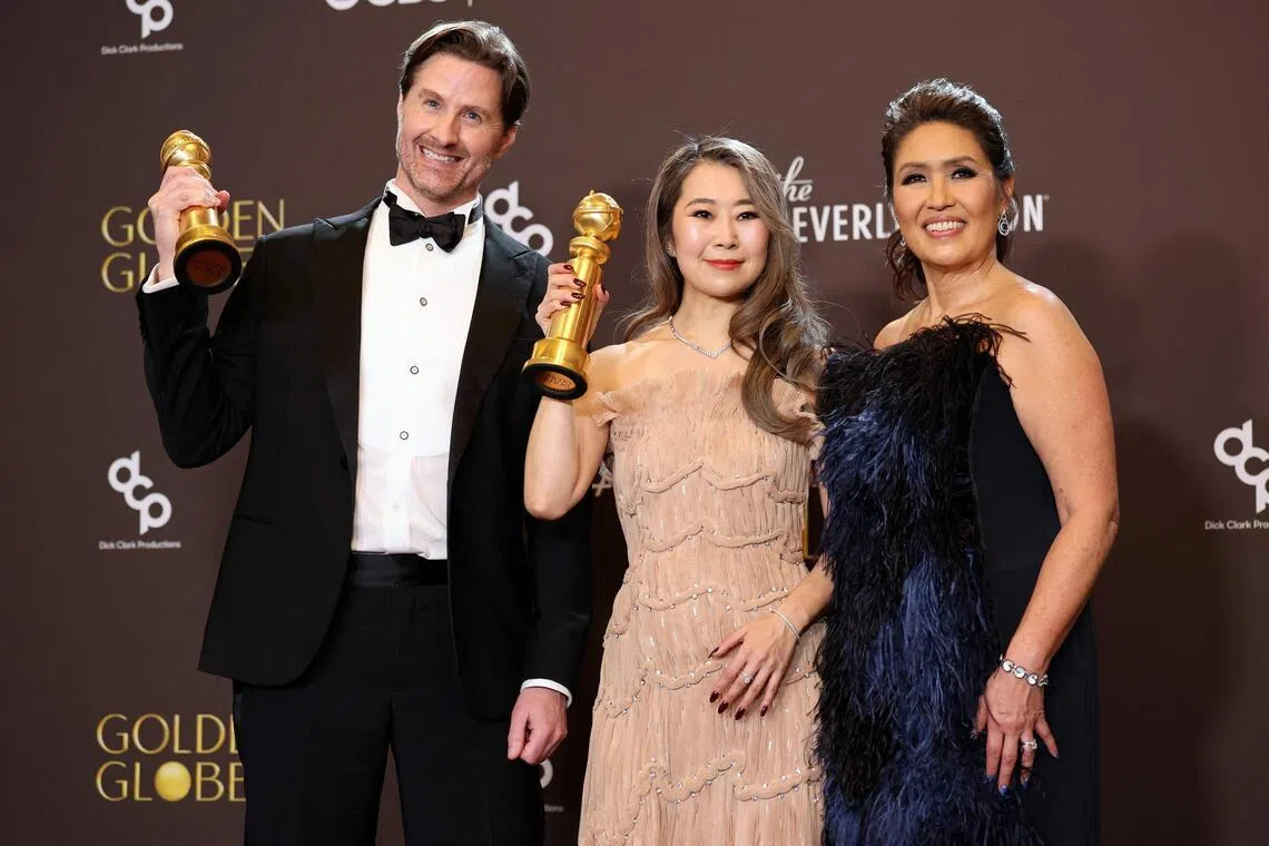 (From left) Chris Appelhans, Maggie Kang and Michelle Wong, winners of best motion picture in the animated category for Kpop Demon Hunters, at the 83rd Annual Golden Globe Awards on Jan 11, 2026.