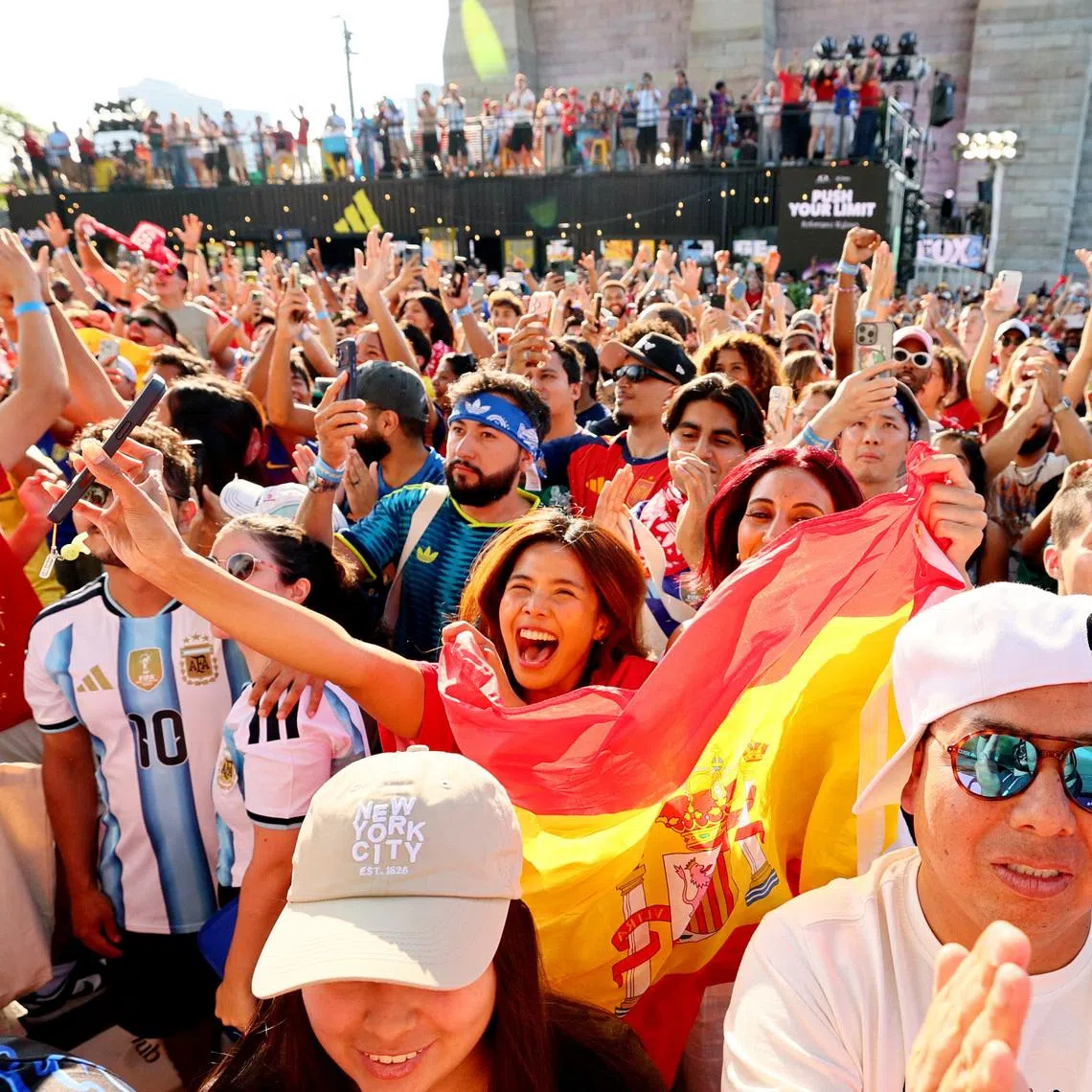 Fans watching the World Cup final between Spain and Argentina at the Brooklyn Bridge park party in New York on July 19.