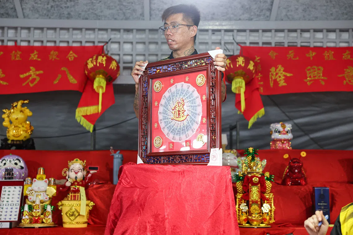 Close-up of a wealth-themed ornament, featuring a circular arrangement of banknotes, during a Hungry Ghost Festival dinner auction in Toa Payoh on Aug 23, 2026. ST PHOTO: BRIAN TEO  