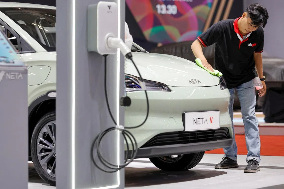 FILE PHOTO: A worker cleans an electric-powered car Neta V, that is displayed during the Gaikindo Indonesia International Auto Show in Tangerang, near Jakarta, Indonesia, August 10, 2023. REUTERS/Willy Kurniawan/File Photo