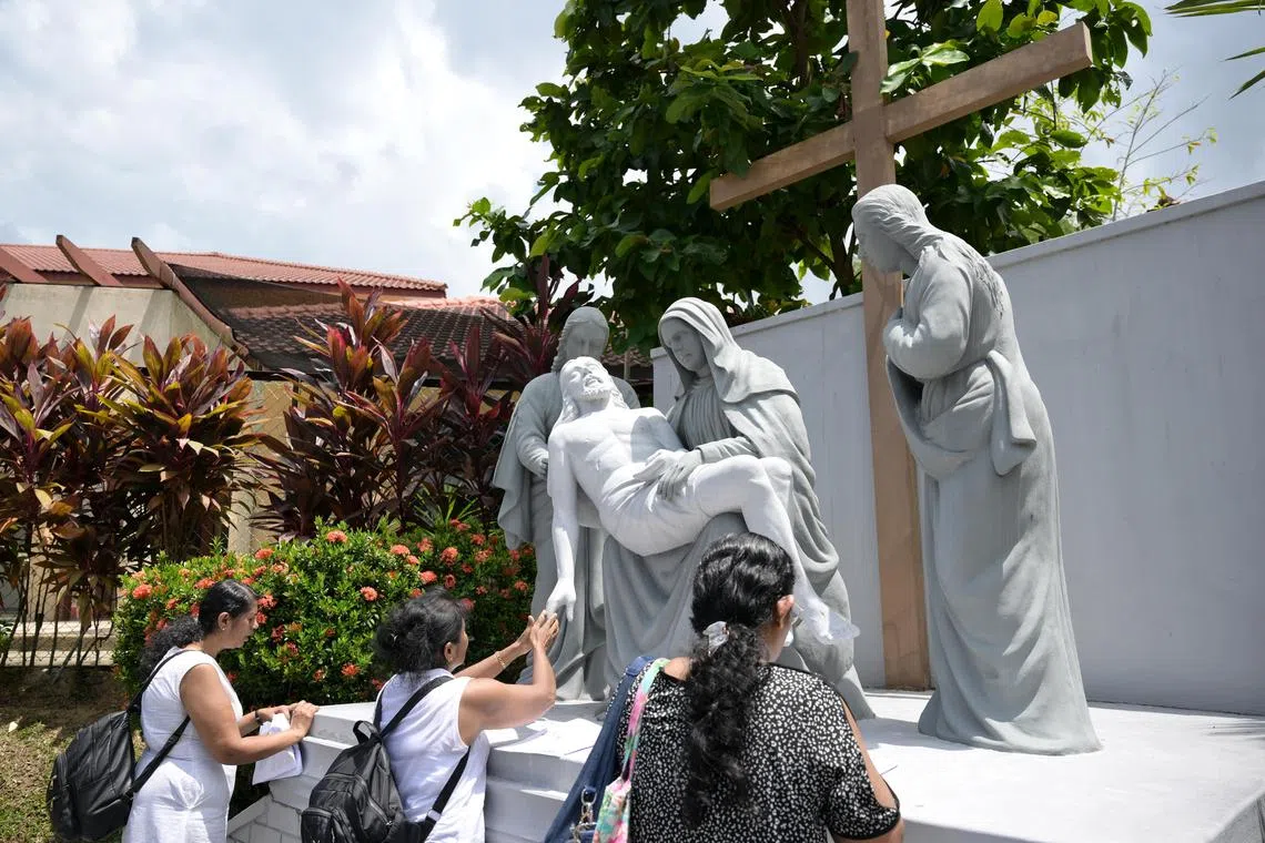 Worshippers from Church of St. Mary of the Angels praying along the Way of the Cross at St. Joseph's Church on Good Friday, March 29, 2024. The Way of the Cross is a special prayer across 14 stations, with each station depicting an event that took place during Jesus's journey to Mount Calvary where he was crucified. 