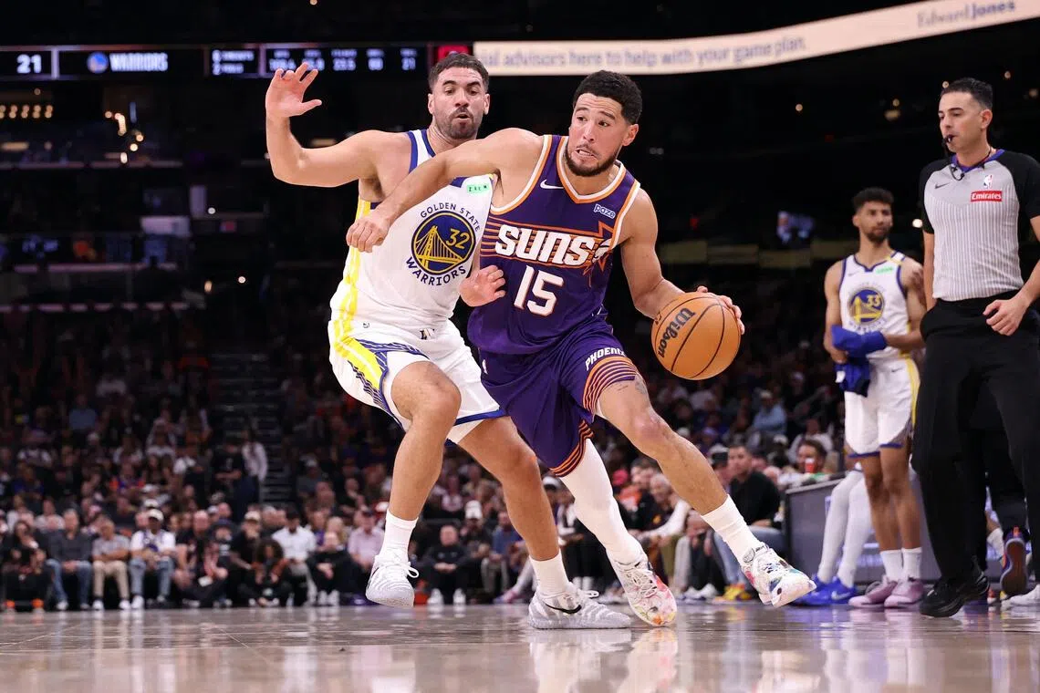 Devin Booker (in the number 15 jersey) had 43 points, seven assists and seven rebounds to help of the Phoenix Suns beat Golden State Warriors 131-122 on Oct 24.