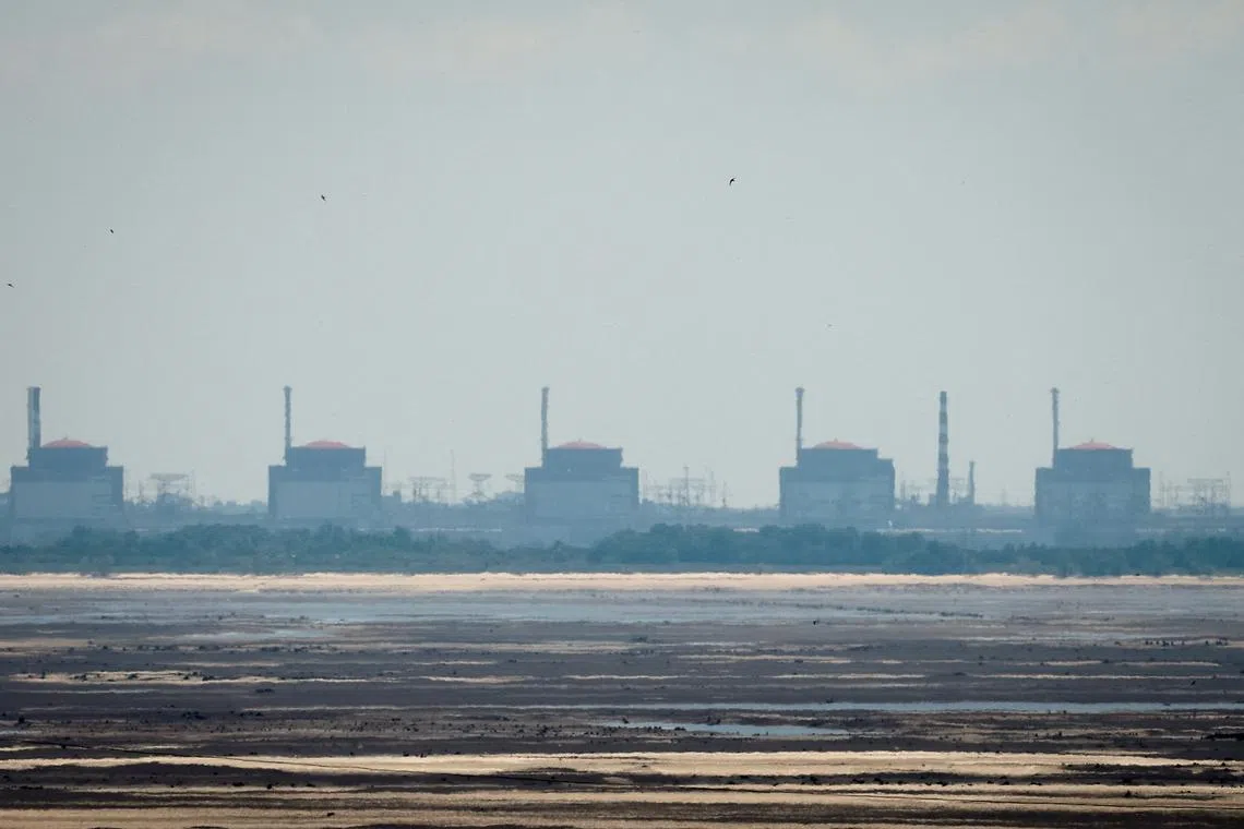 FILE PHOTO: A view shows Zaporizhzhia Nuclear Power Plant from the bank of Kakhovka Reservoir near the town of Nikopol after the Nova Kakhovka dam breached, amid Russia's attack on Ukraine, in Dnipropetrovsk region, Ukraine June 16, 2023. REUTERS/Alina Smutko/File Photo