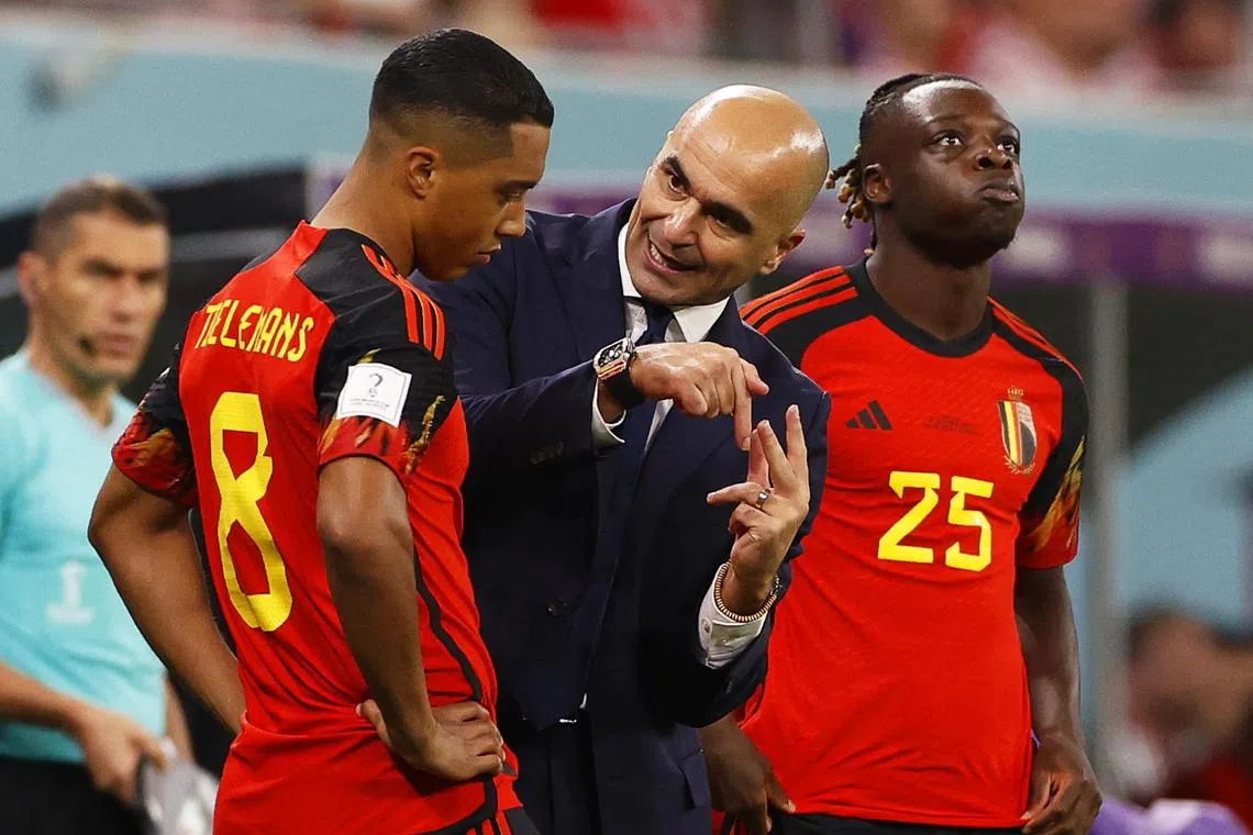 Belgium coach Roberto Martinez gives instructions to Youri Tielemans.