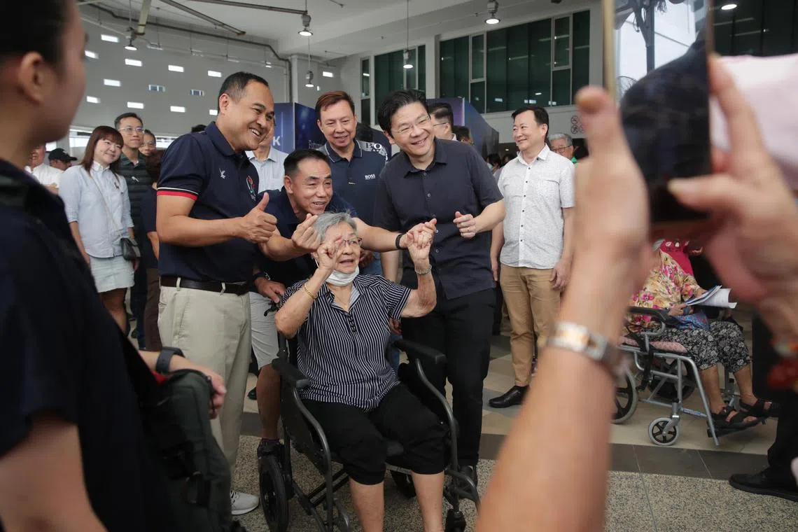 DPM Lawrence Wong and Aljunied GRC grassroots adviser Shamsul Kamar with residents at the Kaki Bukit Constituency’s 40th Anniversary Celebrations event.