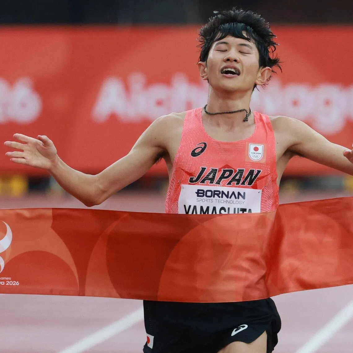 Ichitaka Yamashita crossing the finishing line to win gold in the men’s marathon final of the 2026 Asian Games at Nagoya City Mizuho Park Athletic Stadium in Nagoya, on Sept 26.