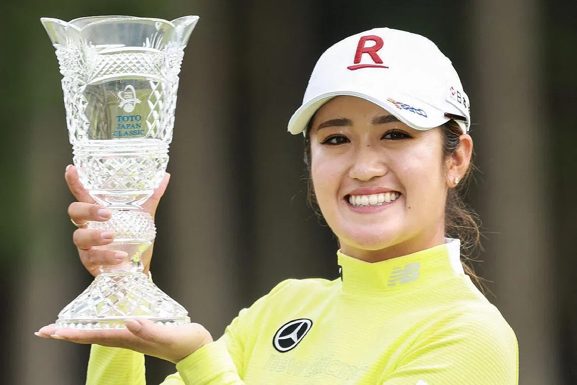 Japan's Mone Inami poses with the trophy after her victory in the final round of the LPGA Japan Classic women's golf tournament on the Minori Course at the Taiheyo Golf Club in Omitama, Ibaraki prefecture on November 5, 2023. (Photo by JIJI Press / AFP) / Japan OUT
