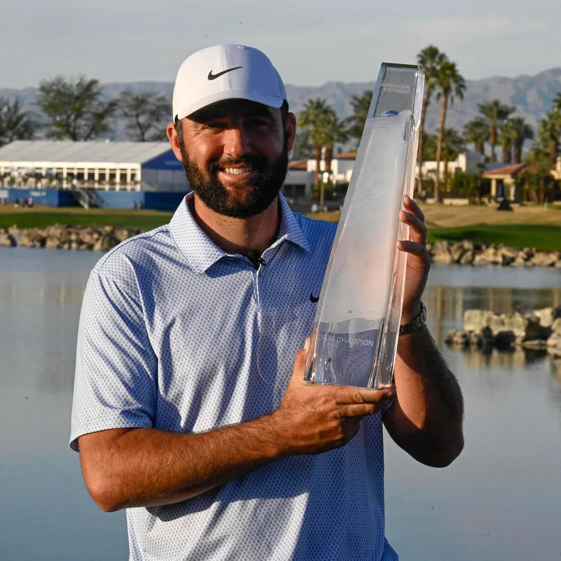 Scottie Scheffler holds the trophy after winning the final round of The American Express 2026 tournament at Pete Dye Stadium Course. 