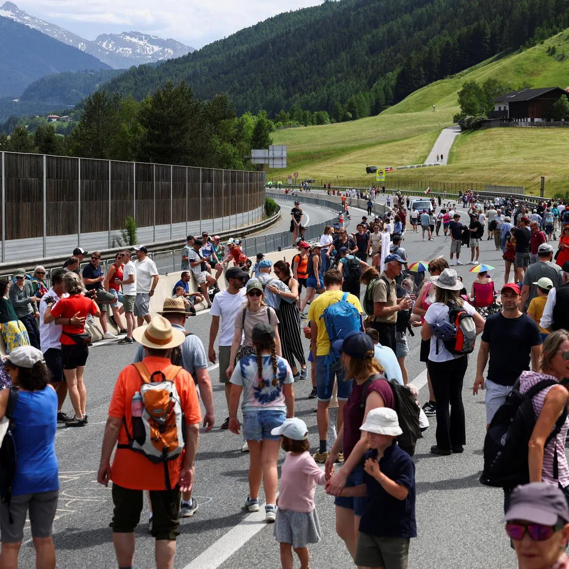 People walk on a closed motorway  as they protest against the growing traffic load on the Brenner motorway between Austria and Italy, near Matrei, Austria, May 30, 2026. REUTERS/Christian Mang