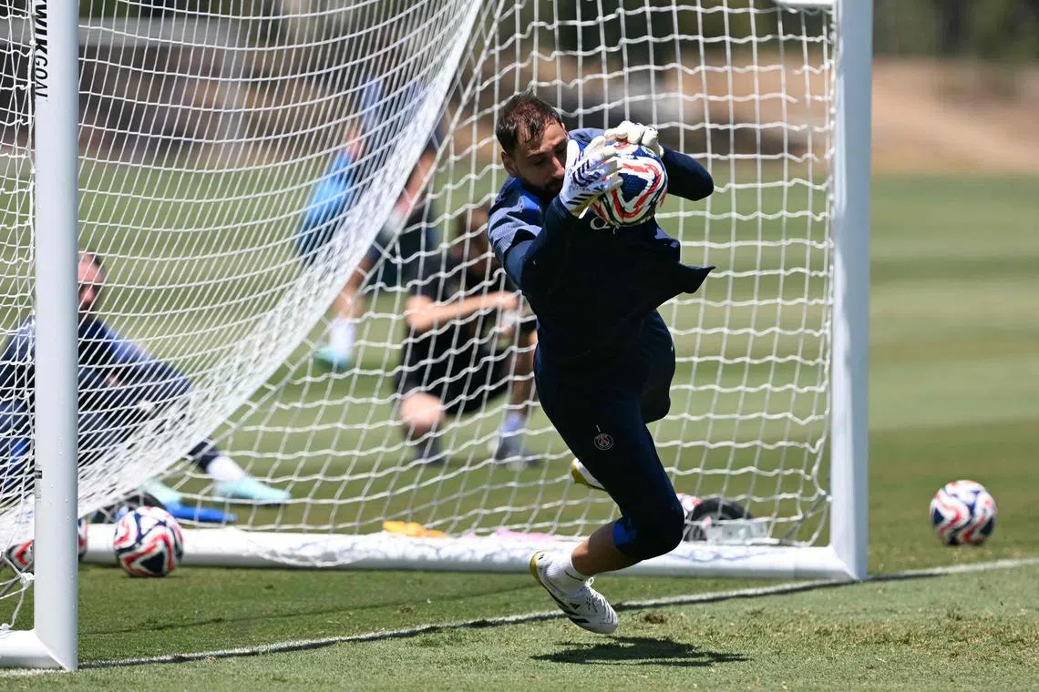 Paris Saint-Germain's Italian goalkeeper Gianluigi Donnarumma jumps for the ball during a training session.