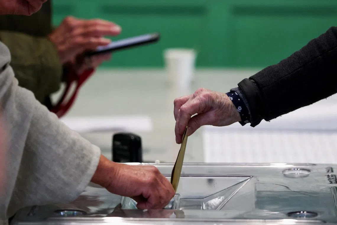 FILE PHOTO: A person votes in the first round of the French mayoral election at a polling station in Paris, France, March 15, 2026. REUTERS/Gonzalo Fuentes/File Photo