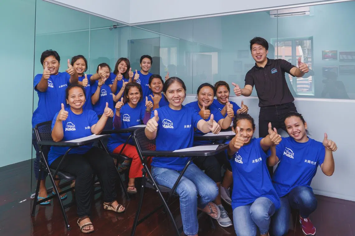 Mr Gabriel Ee (far right, standing) with a group of domestic helpers undergoing training. 