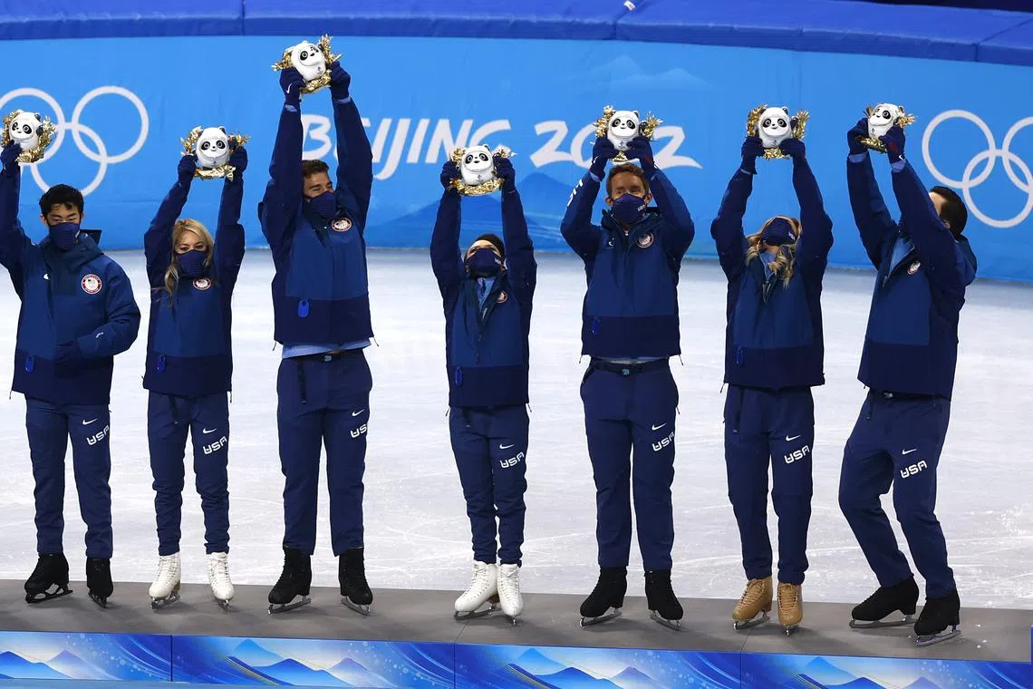 2022 Beijing Olympics - Figure Skating - Team Event - Women Single Skating - Free Skating - Capital Indoor Stadium, Beijing, China - February 7, 2022. Team of United States celebrate on the podium after winning silver during the flower ceremony. REUTERS/Evgenia Novozhenina/File Photo