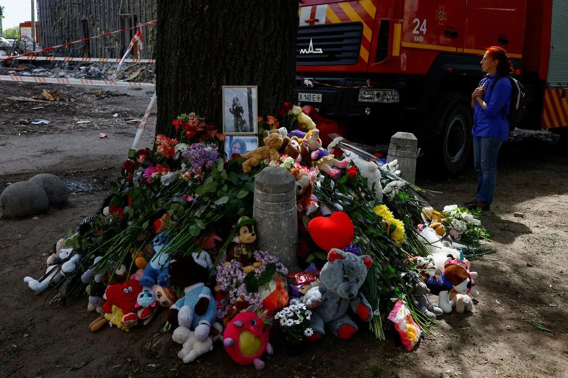 A makeshift memorial at the site of an apartment building where 24 residents were killed by a Russian missile strike.