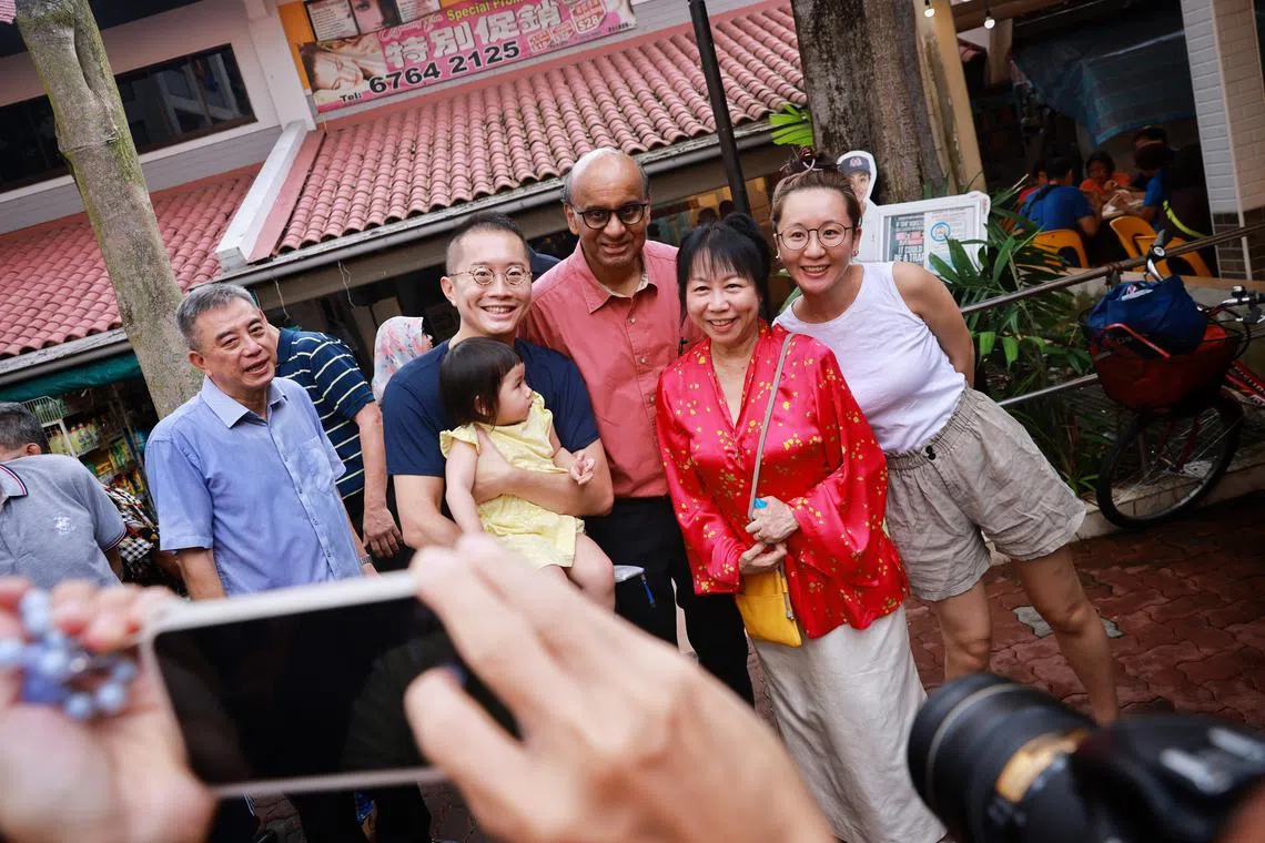 Mr Tharman Shanmugaratnam (centre) and his wife Jane Yumiko Ittogi (in red) meeting residents on July 15, 2023.