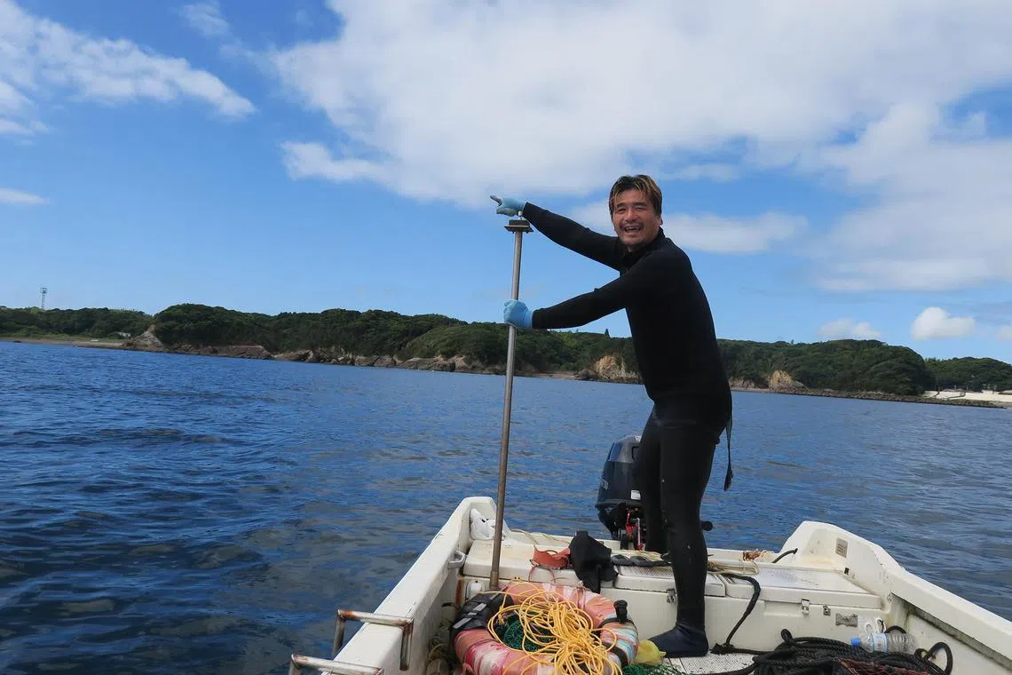Ama diver Yushi Ikeda, 37, on his boat.