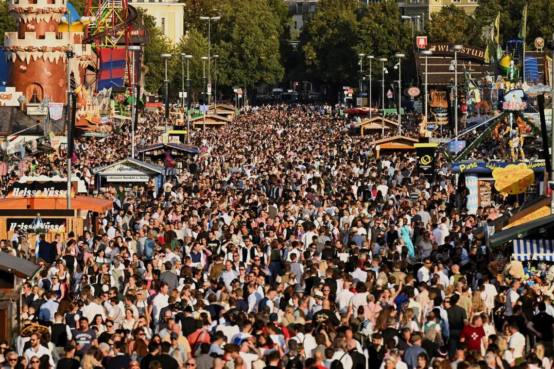 FILE PHOTO: A crowd moves through the venue on the last day of the Oktoberfest in Munich, Germany, October 3, 2023. REUTERS/Angelika Warmuth/File Photo