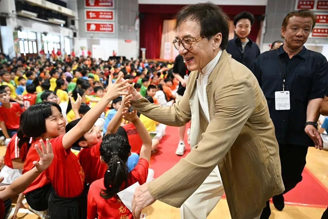 ST20260707_202680600754/sfjackie07/Shintaro Tay// Actor Jackie Chan interacting with students at Pei Chun Public School on July 7, 2026.