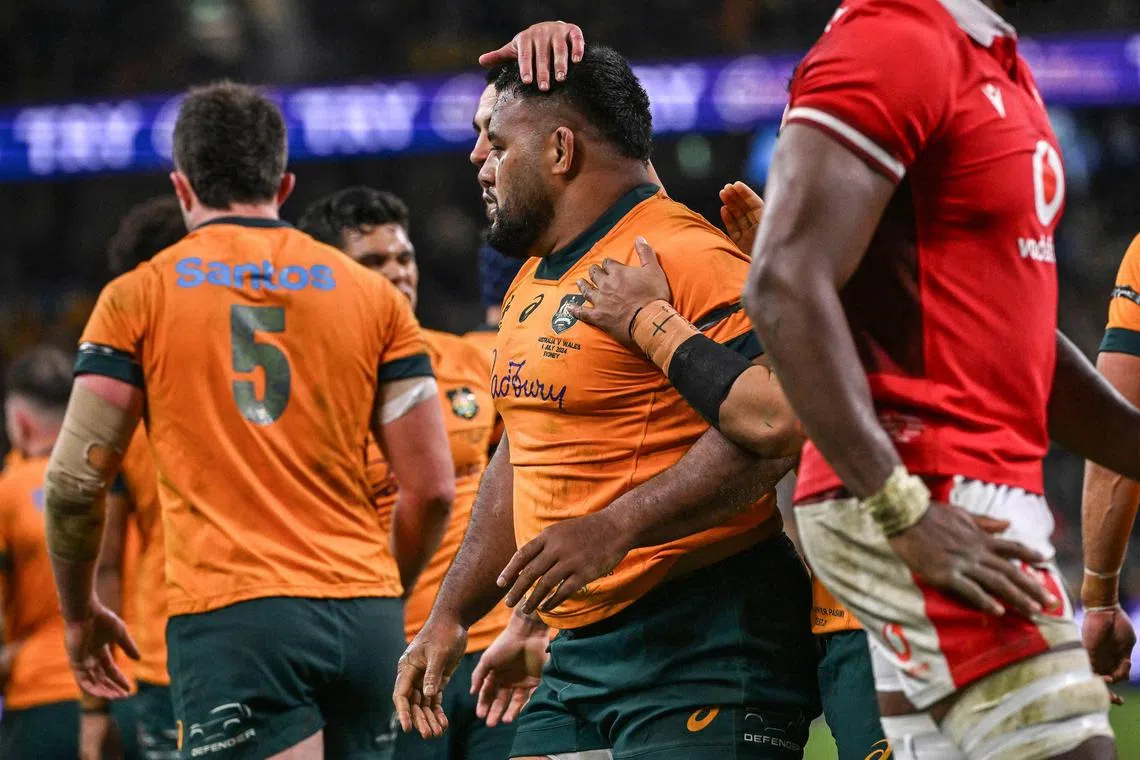 Taniela Tupou is congratulated by Australia teammates after scoring a try in the rugby union Test against Wales at Allianz Stadium in Sydney on July 6, 2024.