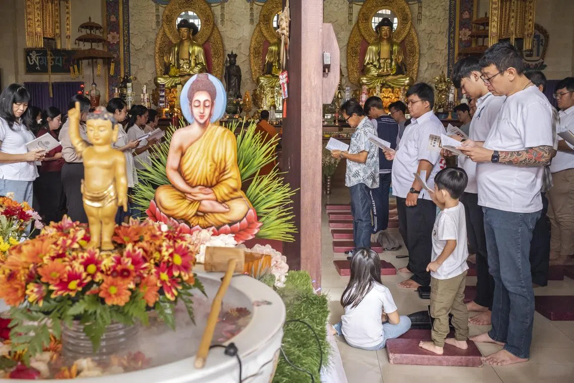 Devotees taking part in Vesak Day celebrations at a temple in Denpasar, Bali, Indonesia, on June 4, 2023. Buddhists celebrate Vesak Day to mark the date of the birth, enlightenment and passing of Buddha.