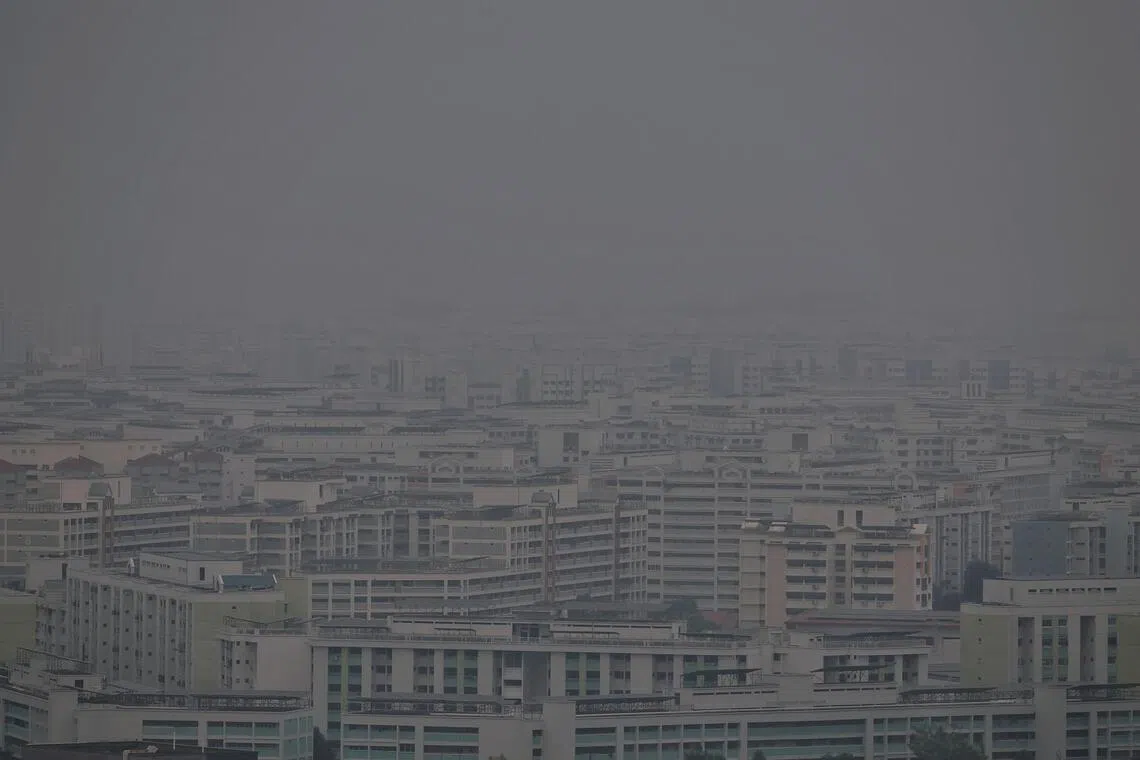 Buildings in Woodlands, as seen towards the northeastern direction, during hazy conditions at 6.15pm on Oct 23, 2026. The 24-hr PSI is 85 with 1-hr PM2.5 at 80 in the northen part of Singapore at 6pm. ST PHOTO: KEVIN LIM pixhaze23