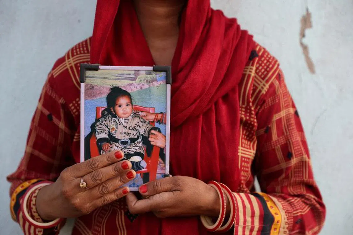 FILE PHOTO: Poli Devi, whose 11-month-old daughter Janvi was among the children who died due to kidney injury after consuming contaminated cough syrup, holds a photo of her at their house in Ramnagar on the outskirts of Jammu, India, March 28, 2023. REUTERS/Anushree Fadnavis/File Photo