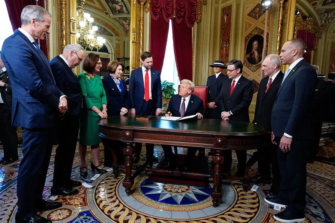 Newly sworn-in President Donald Trump takes part in a signing ceremony in the President's Room following the inaugural ceremony at the US Capitol on Jan 20, 2025. 