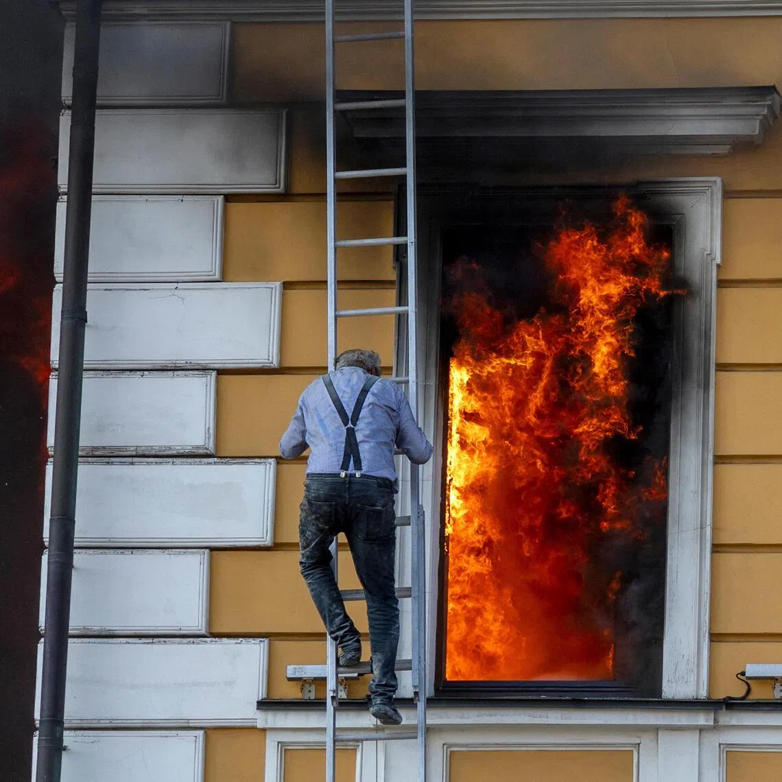 A man escaping from the National Academy of Sciences in Kyiv, Ukraine, after it was hit by a Russian jet-powered drone on Sept 28.