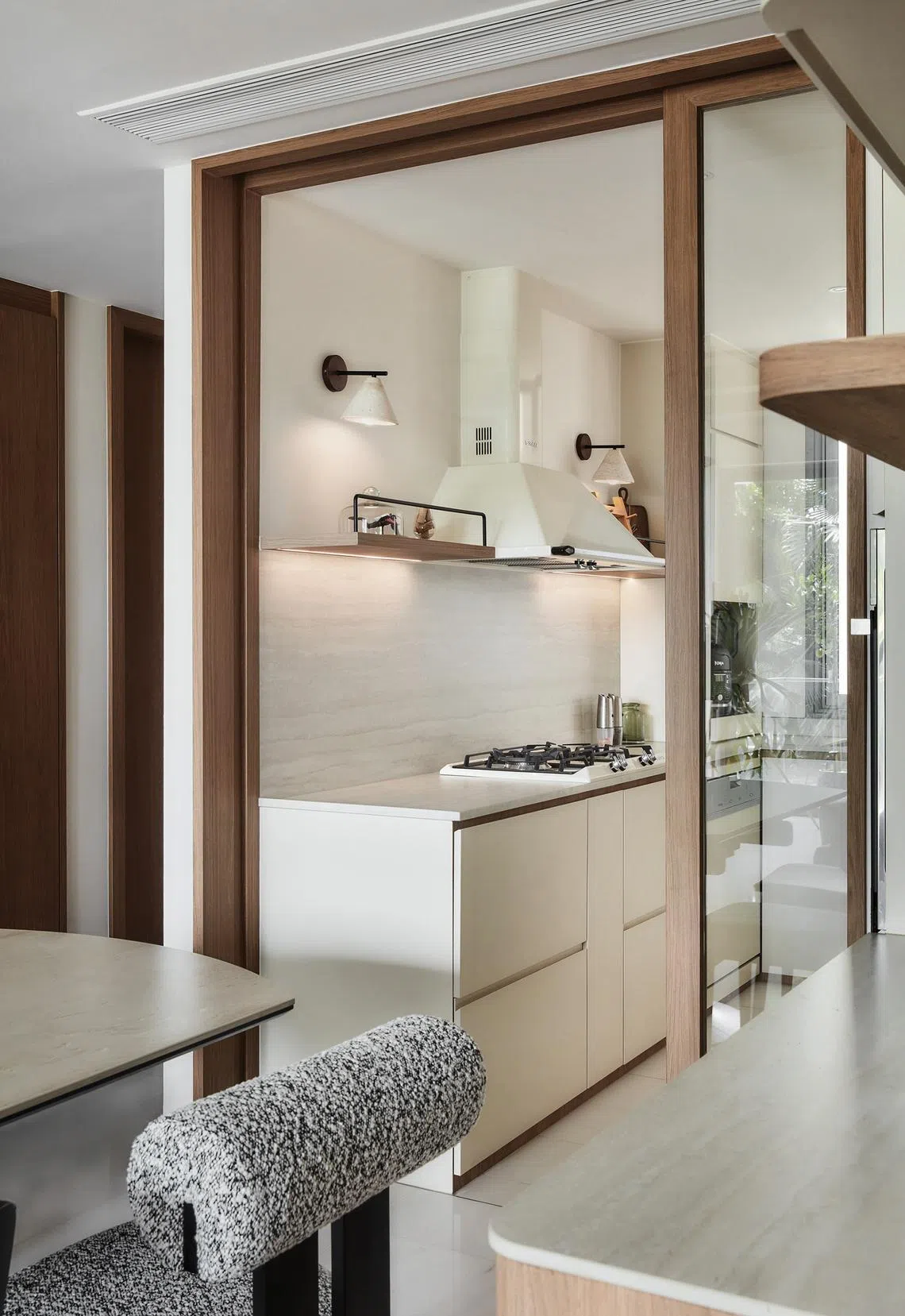 A mix of open shelves and concealed storage makes the compact kitchen feel uncluttered.