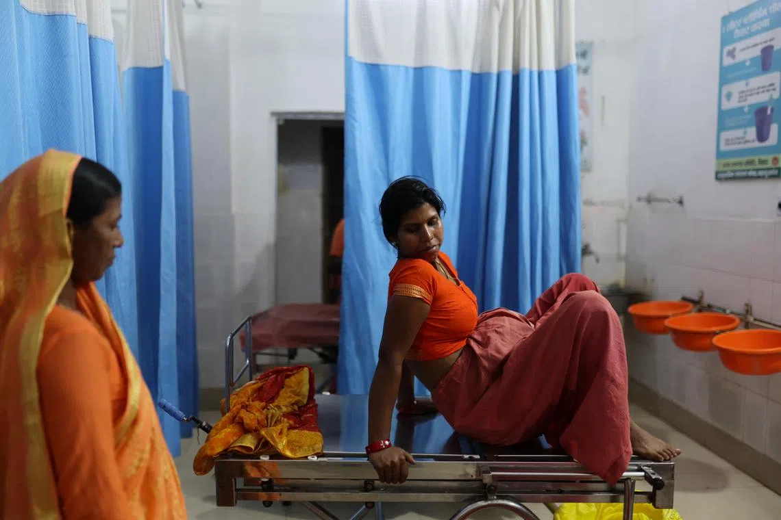 Sabina Begum, 22, sitting before giving birth to her child, at the labour ward of a community health centre in Bahadurganj subdivision on March 21. "I talk to women while they are experiencing labour pain and nudge them to undergo sterilisation immediately after delivery," said Parvati Rajak, a medical officer. "But the final choice is always made by the family".          