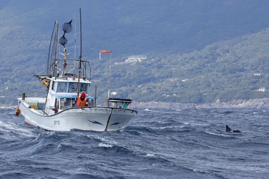 An object believed to belong to the U.S. military aircraft V-22 Osprey that crashed into the sea floats next to a fishing boat at the sea off Yakushima Island, Kagoshima prefecture, western Japan November 30, 2023, in this photo taken by Kyodo. Mandatory credit Kyodo via REUTERS